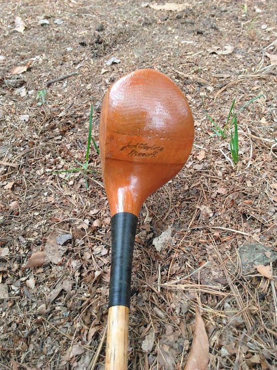 a close up of a wooden paddle on the ground