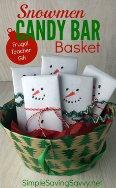 a bucket filled with white paper snowmen on top of a wooden table