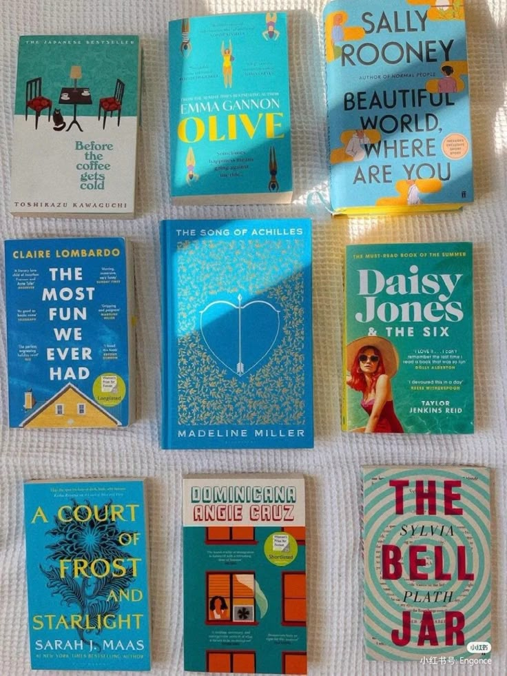 there are many different books on the bed with each one's cover pulled up