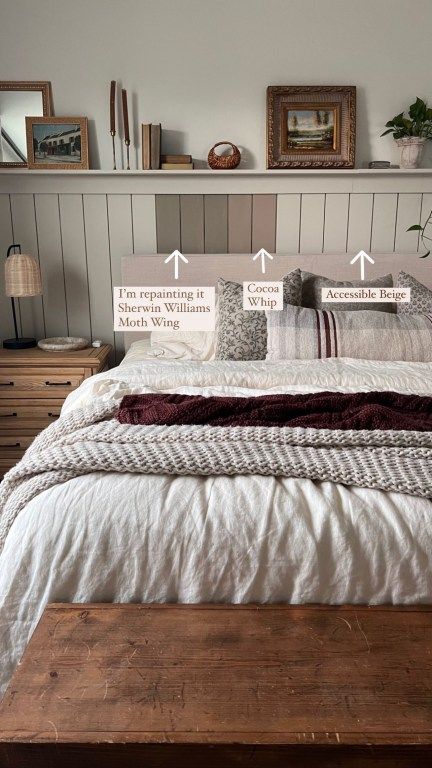 a bed with white sheets and pillows on top of it next to a wooden headboard