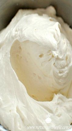 a bowl filled with white cream sitting on top of a table