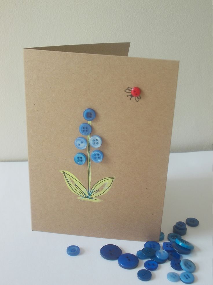 a card with blue buttons and a flower on it