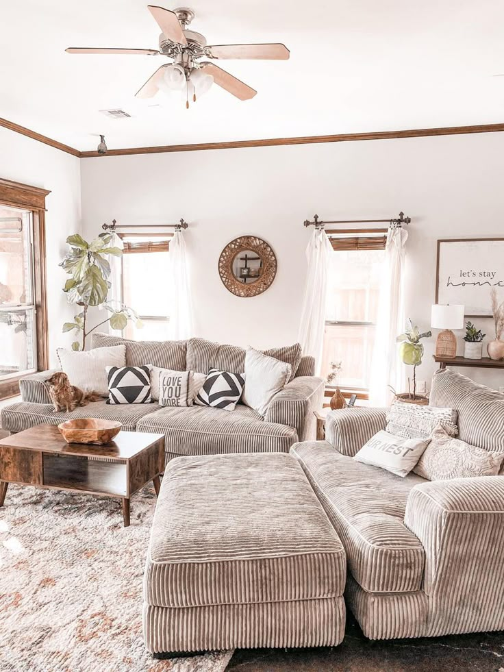 a living room filled with furniture and a ceiling fan