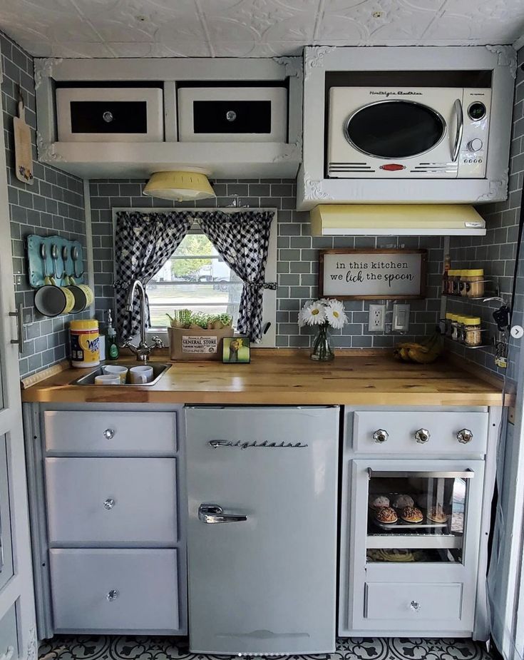 an old fashioned kitchen with white appliances and gray tile