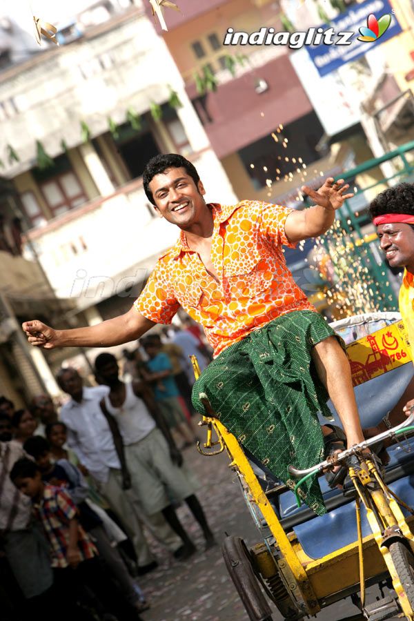 a man riding on the back of a yellow cart with water pouring out of it