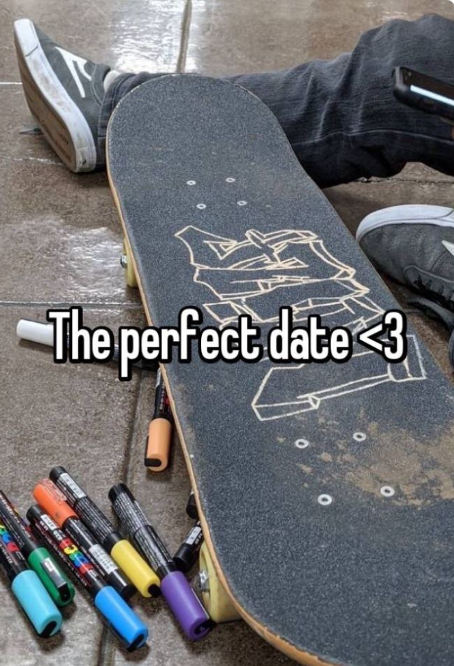 a person laying on the ground next to a skateboard with markers in front of them