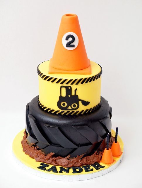 a birthday cake made to look like a construction site with an orange cone on top