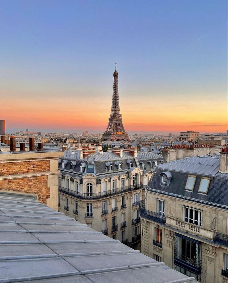 the eiffel tower towering over the city of paris, france at sunset or dawn