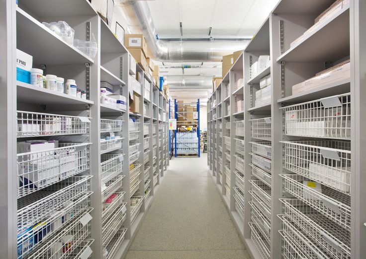 an aisle in a large warehouse filled with lots of shelves