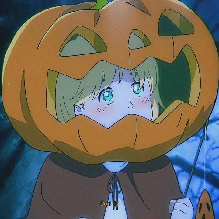 a girl in a pumpkin costume holding a stick