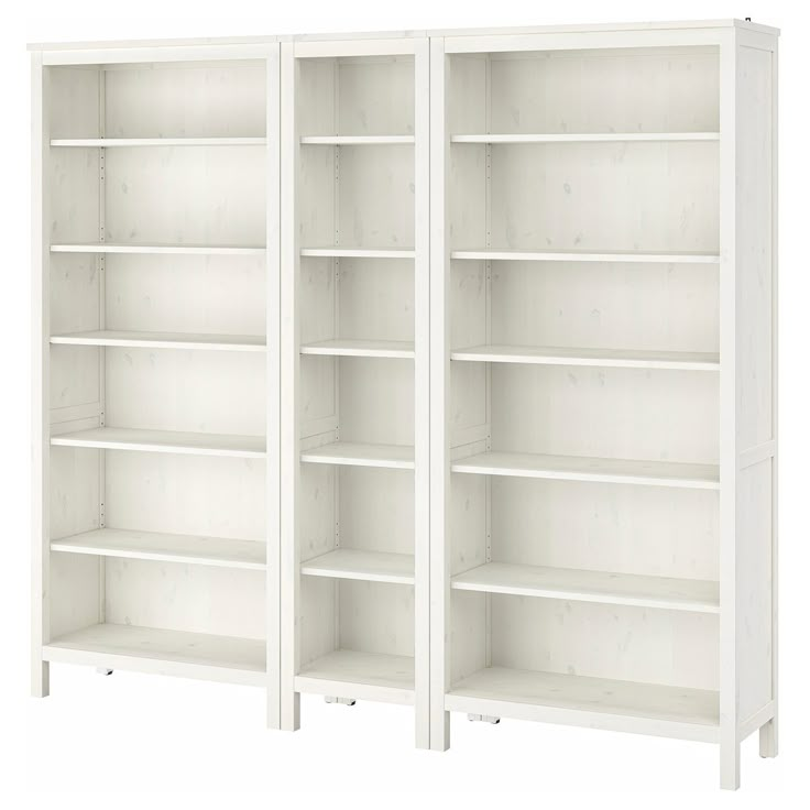 two white bookcases sitting next to each other on top of a white floor