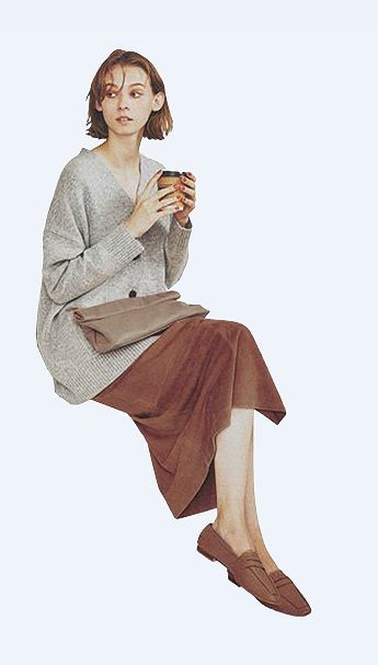 a woman sitting on the ground holding a cup