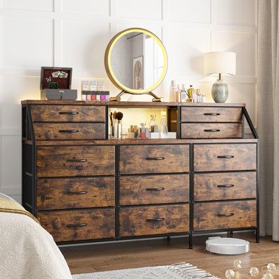 a bedroom with a dresser and mirror in it