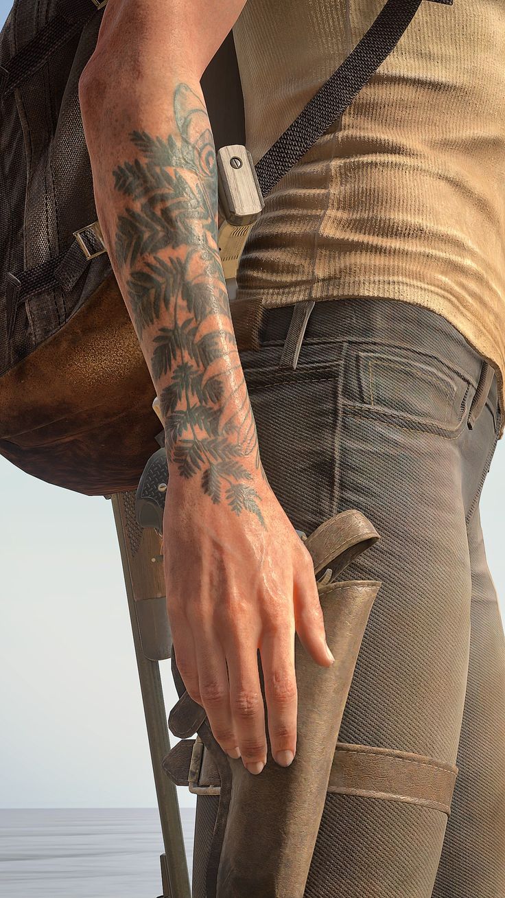 a man with tattoos on his arm holding a camera