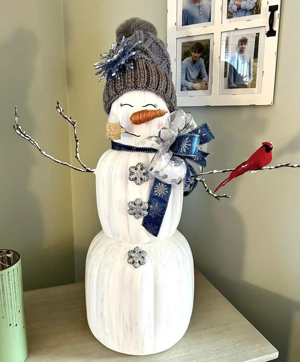 a snowman with a hat and scarf on top of a table