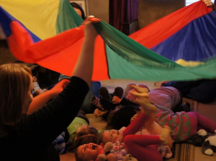 a group of people laying on the floor with kites