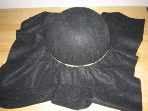 a black hat sitting on top of a wooden table