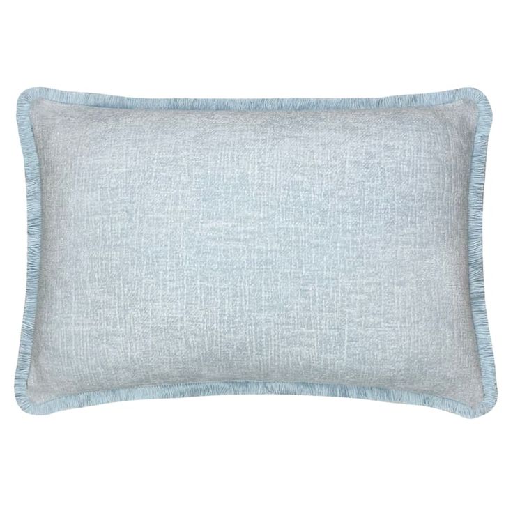 a light blue pillow with fringes on the front and back of it, against a white background