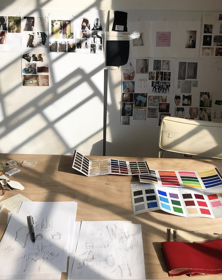 the table is covered with papers and pictures