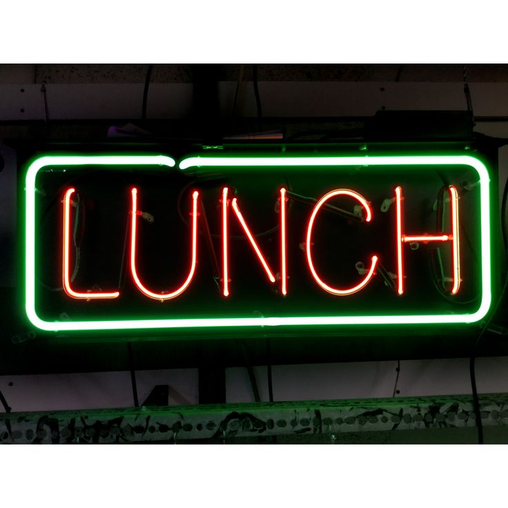 a green neon sign that says lunch on it's side hanging from the ceiling