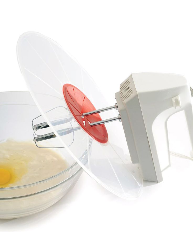 an electric hand mixer mixing eggs in a bowl