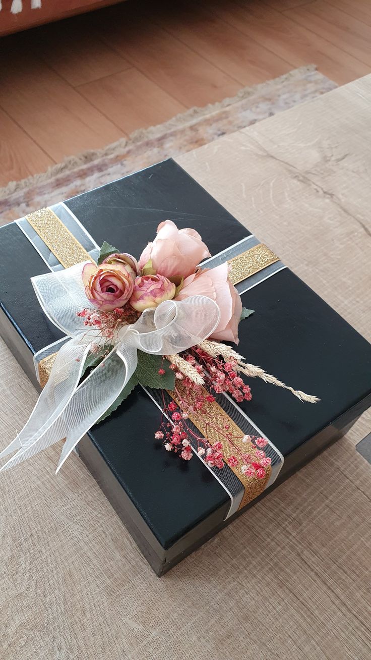 a black box with flowers on it sitting on the floor