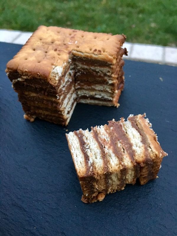 two pieces of cake sitting on top of a blue tablecloth next to each other