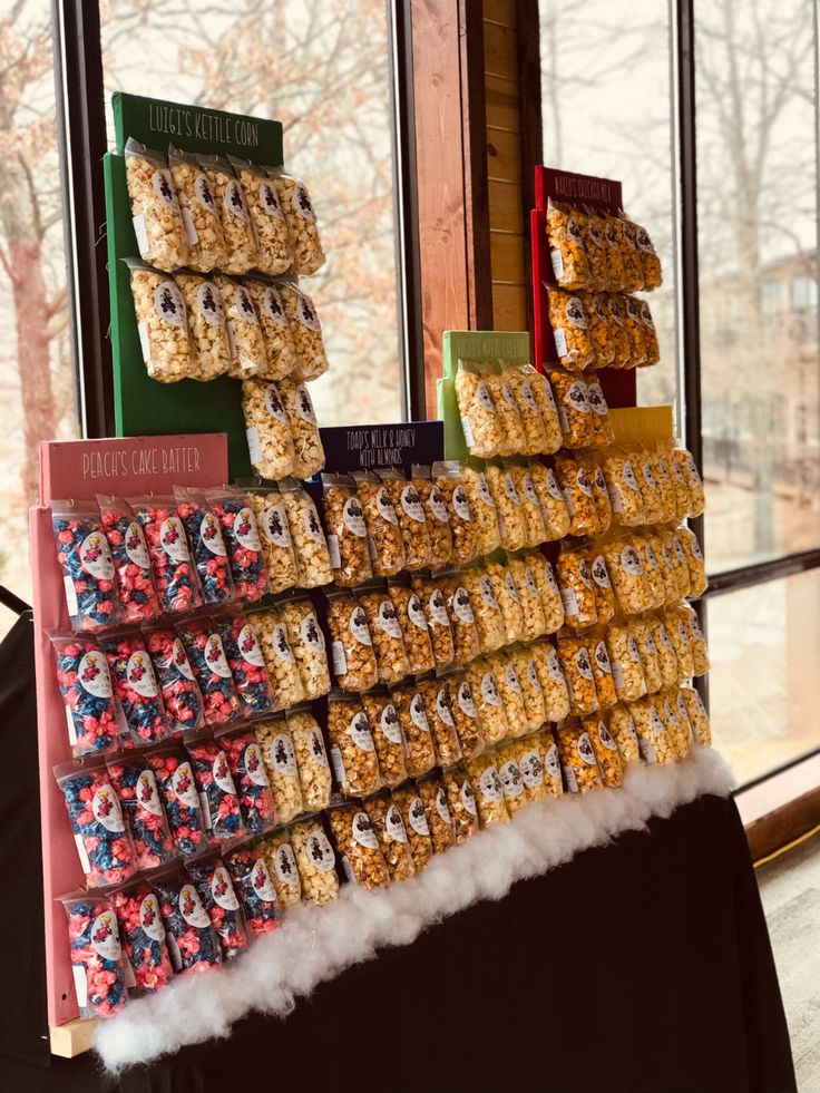 several boxes of cereal are stacked on top of each other in front of a window