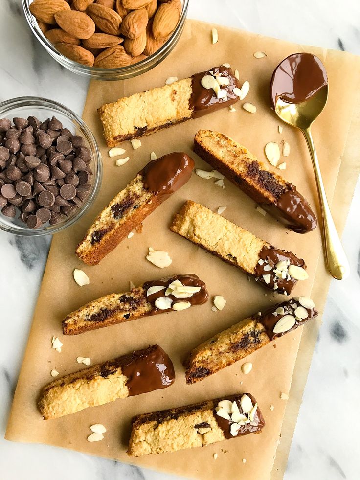 almonds, chocolate and peanut butter on parchment paper