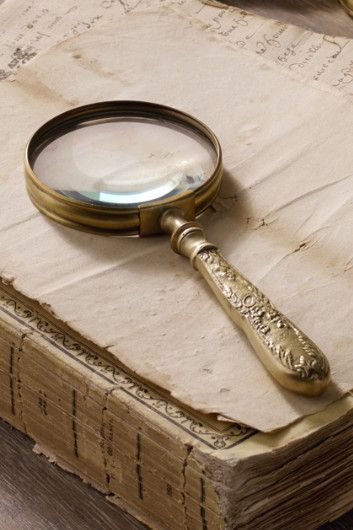 a magnifying glass sitting on top of an old book