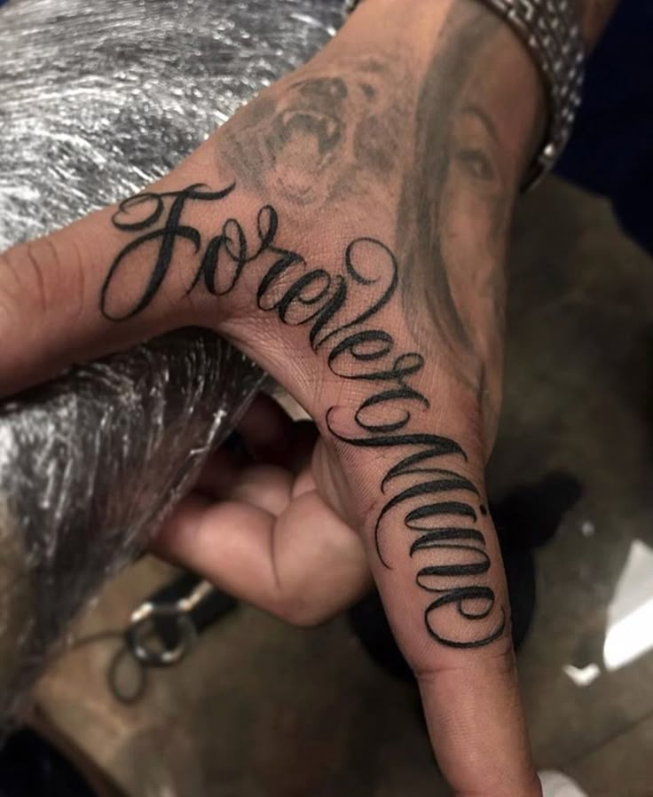 a person's hand with the words for love and money tattooed on it,