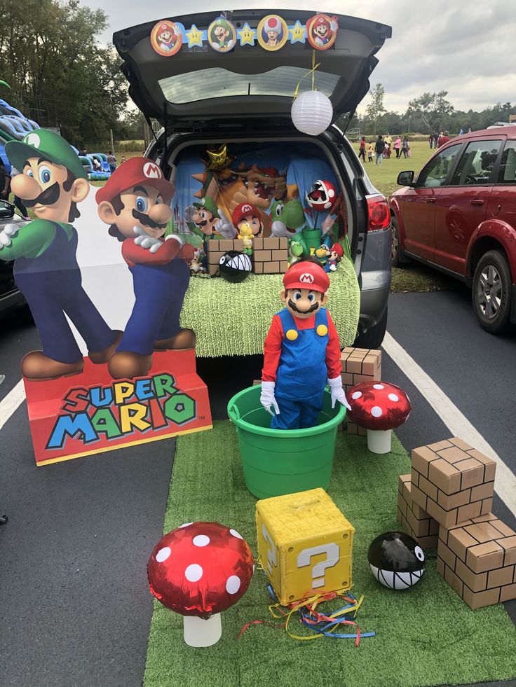 the back of a car with mario and luigi's birthday decorations on display in it