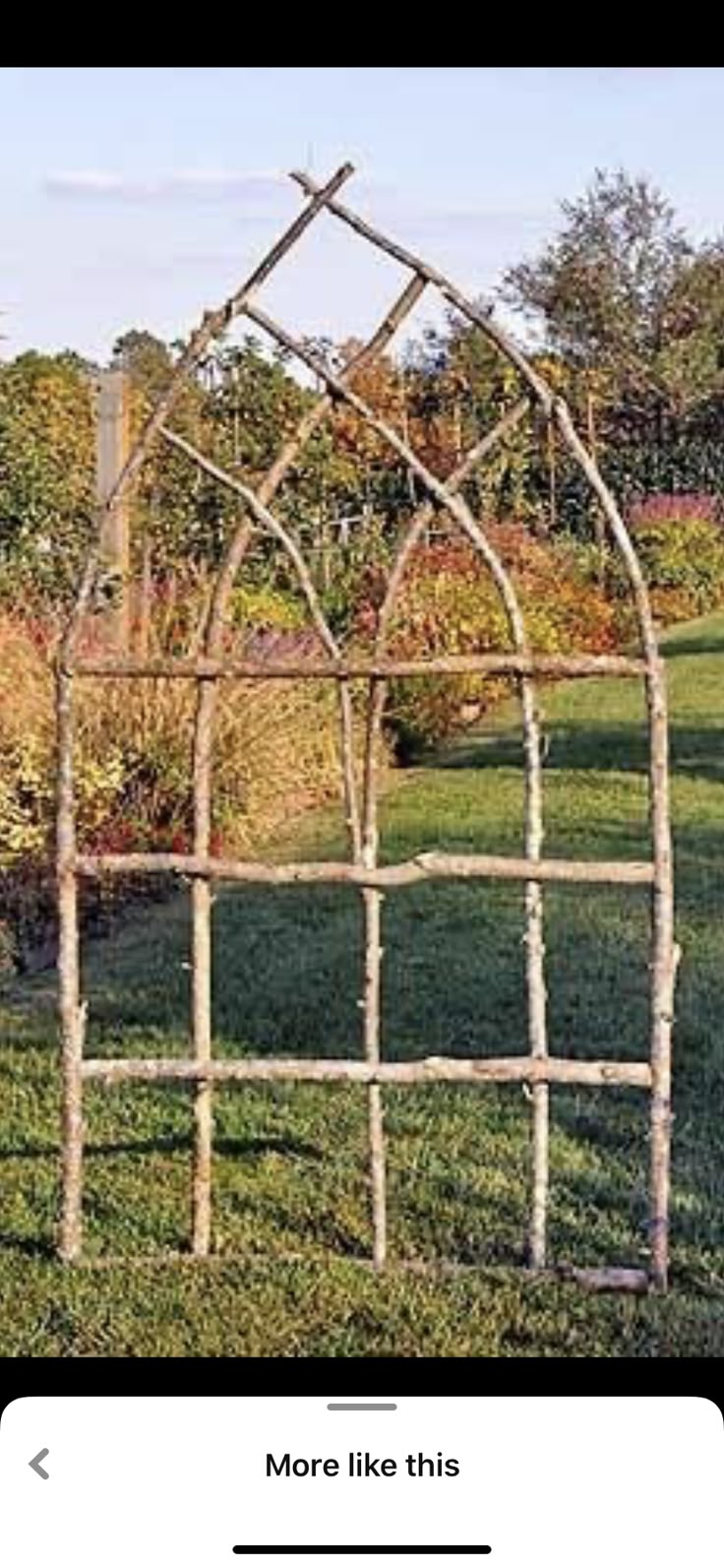 an old iron garden trellis in the grass