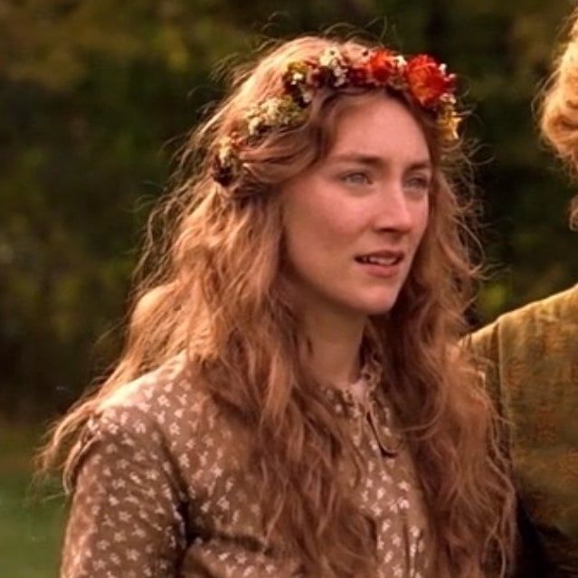 two women with flowers in their hair standing next to each other