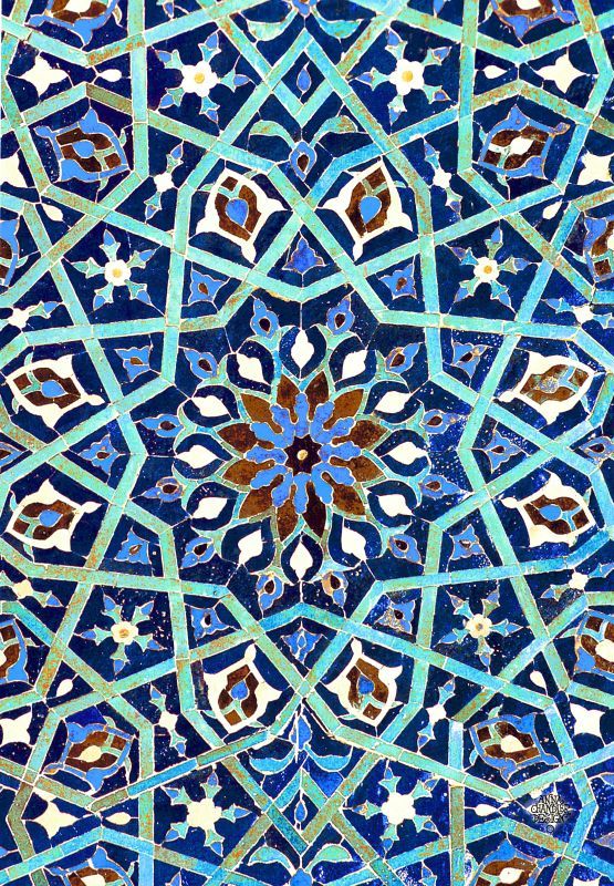 an intricate blue and brown tile design with many different colors on it's surface