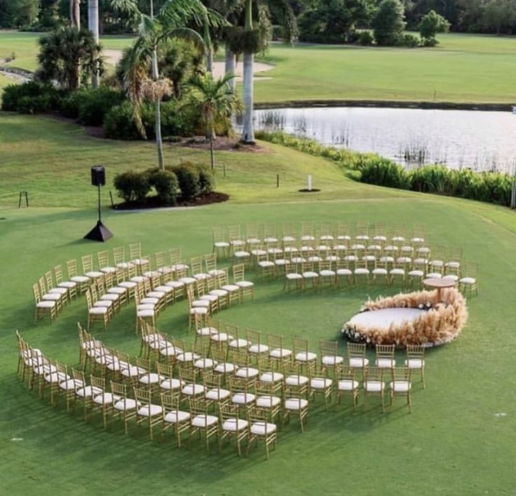 an outdoor ceremony setup with chairs and flowers