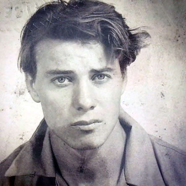 an old black and white photo of a young man with hair blowing in the wind