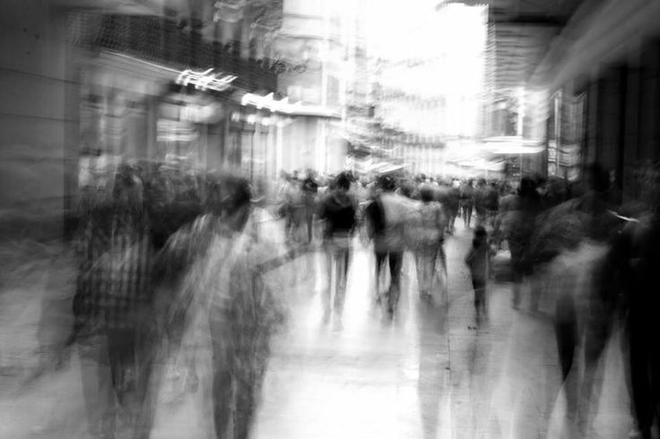 blurry image of people walking down the street