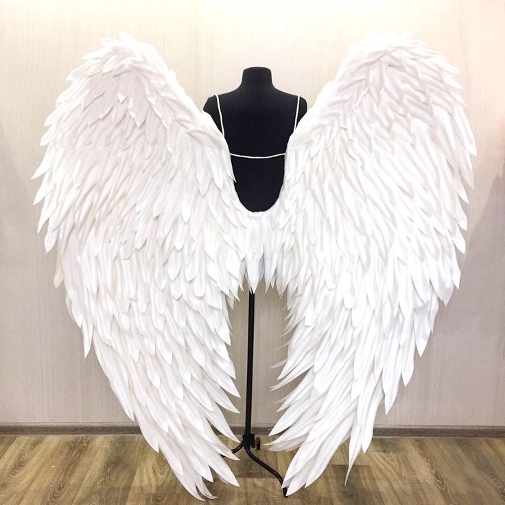 a mannequin with large white wings on it