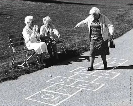 three elderly women playing hopo game in the park