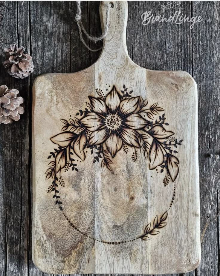 a wooden cutting board with flowers on it