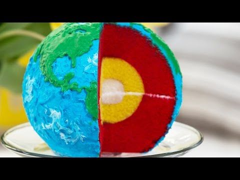 a cake shaped like the earth on top of a glass plate