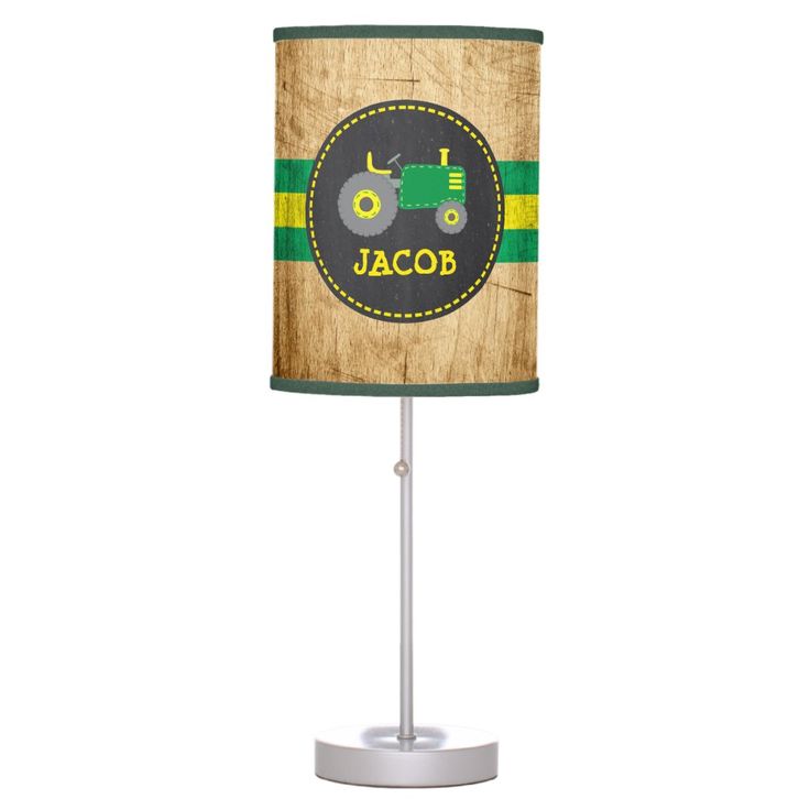 a lamp with a tractor on it and the name jacor written in green