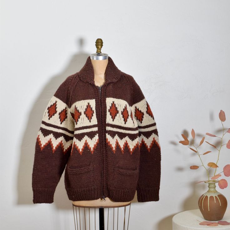 So in love with this perfect 1970s hand knit Cowichan sweater jacket. Gorgeous autumn pallet and minimalist graphic motif that wraps around. Heavy duty front zip and front pockets. Cozy heavy weight. Perfect for fall/winter. Good condition with normal wear to knit for age.  MEASUREMENTS: BUST: 46" WAIST: 46" HIP: 46" LENGTH: 28" Dark Academia Knitting, Retro Knitted Outerwear For Fall, Vintage Jacquard Knit Cardigan For Fall, Vintage Winter Jacquard Knit Cardigan, Vintage Fair Isle Pattern Outerwear For Fall, Vintage Fair Isle Outerwear For Fall, Retro Wool Sweater With Fair Isle Pattern, Vintage Jacquard Knit Winter Outerwear, Retro Fair Isle Pattern Outerwear For Fall