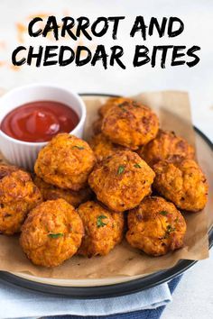 carrot and cheddar bites on a plate with ketchup in a bowl