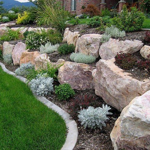 a large rock garden in front of a house