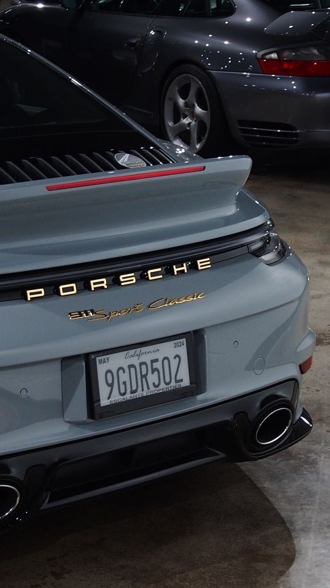 the back end of a porsche parked in a garage