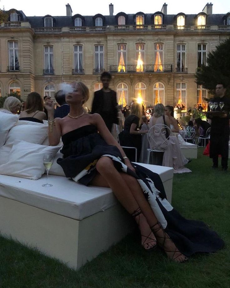 a woman sitting on top of a white bench