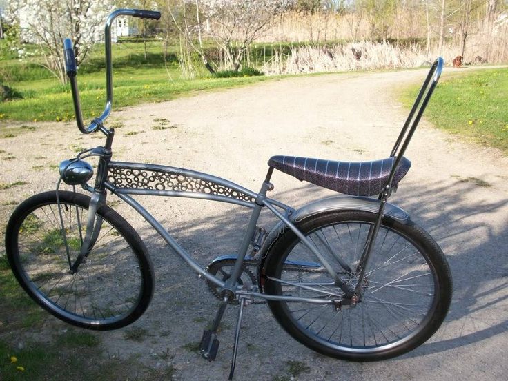 an old fashioned bicycle parked on the side of a road