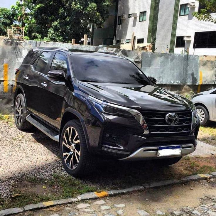 a black suv parked in front of a building